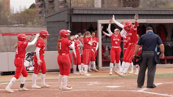 Kylie Doherty jumps onto home plate as part of her three-run homer celebration.