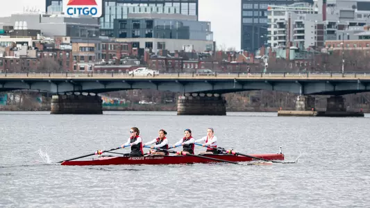 Photo of the BU Lightweight Rowing Varsity 4 racing on the Charles River.