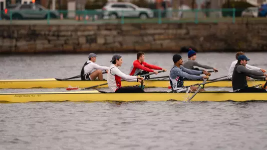 Photo of two BU Men's Rowing eights practicing on the Charles River.