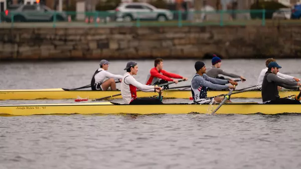 Photo of two BU Men's Rowing eights practicing on the Charles River.