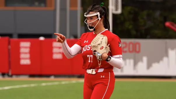 Kasey Ricard points her finger with a big smile toward home plate