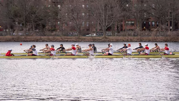 Photo of the BU Men's Rowing Varsity 8 racing against Northeastern.