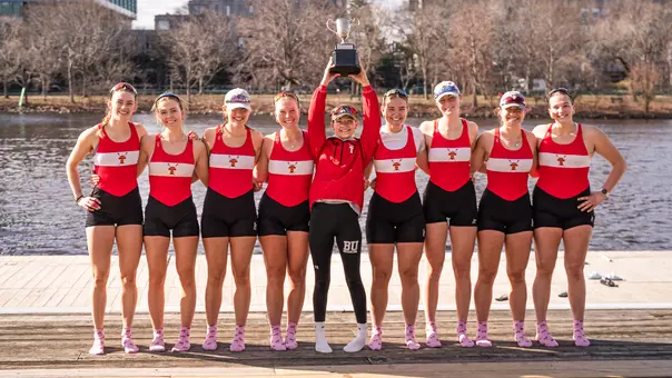Women's Rowing Varsity 8+ Lifts the Council Cup on the dock of DeWolfe Boathouse