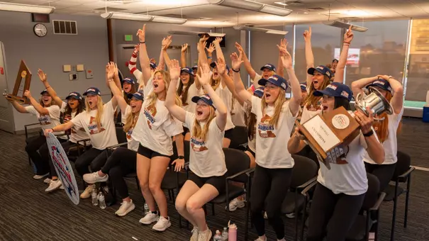 Boston University softball team jumps up in celebration after hearing their name called during the NCAA selection show on ESPN2