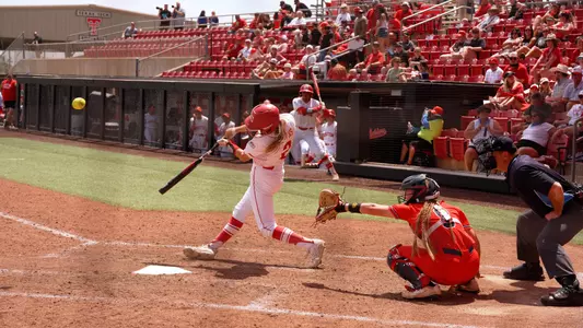 Camryn Lyons makes contact with a pitching swinging left handed at home plate