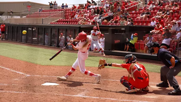 Camryn Lyons makes contact with a pitching swinging left handed at home plate