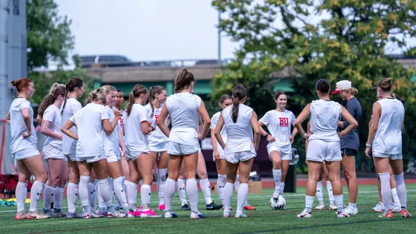 Women's Soccer in a circle at preseason practice
