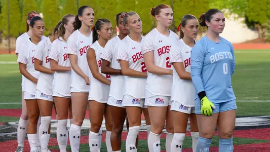 Women's soccer standing for the national anthem