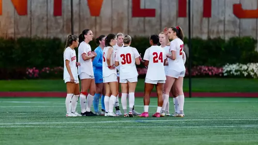 Women's soccer huddle on the field