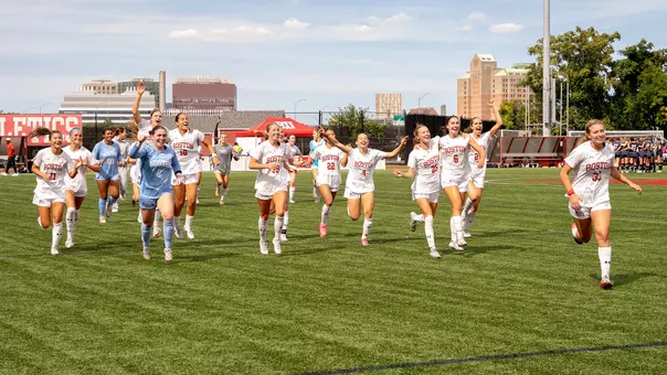 Photo of the BU Women's Soccer team celebrating the win over Navy.