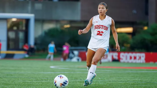 Photo of BU women's soccer freshman Sam Ryan passing the ball at Nickerson Field.