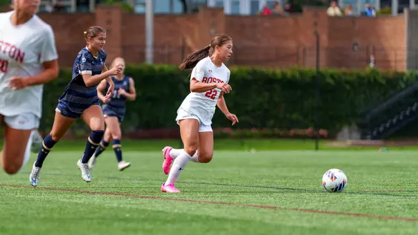Photo of BU women's soccer freshman Sam Ryan dribbling the ball at Nickerson Field.