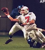 Memphis defenders put<br>pressure on Louisville<br>quarterback Chris Redman<br>during Saturday's game.