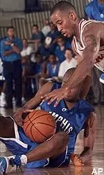 Keiron Shine, bottom, struggles to control the ball under USC guard Brandon Granville in the first half.