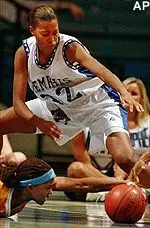 Deanna Farr looks to grab the ball from Tennessee's Tamika Catchings in the first half of a 92-69 Tiger loss Tuesday.