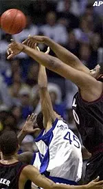 Temple center Ron Rollers passes over Kelly Wise during the first half.