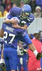 Memphis place kicker Ryan White celebrates with holder Michael Harris after White kicked a field goal as time ran out in the second quarter.