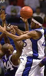 Kansas State's Kelvin Howell, left, battles for a loose ball with Memphis' Kelly Wise, right, and Earl Barron, back, at the Pyramid in Memphis, Tenn., Saturday, Dec. 30, 2000. Memphis won 81-58.