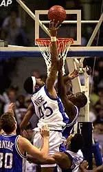 Kelly Wise goes up for a shot over Saint Louis' Jason Edwin during the Tigers' 72-63 victory.