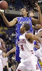 Forward Arthur Barclay goes up for a shot between Alabama guards Terrance Meade and Rod Grizzard during the first half of their consolation game in the Guardians Classic tournament.