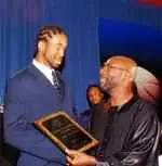 University of Memphis forward Kelly Wise is presented the team's most valuable player award at "The Banquet" by Isaac Hayes.