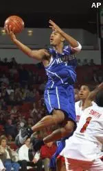 Guard Antonio Burks goes to the basket over Houston guard Dominic Smith during the first half.