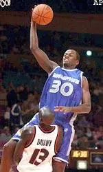Earl Barron drives to the basket over Kueth Duany of Syracuse during the first half in the Coaches vs. Cancer Classic.