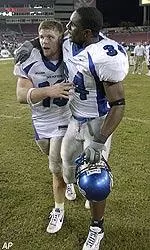 Quarterback Danny Wimprine, left, and teammate Robert Douglas leave the field after Saturday's game.