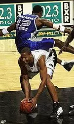 Billy Richmond falls on the back of Missouri's Travon Bryant as they battle for a rebound during the second half.