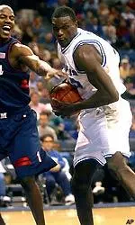 Memphis center Modibo Diarra tries to drive around Mississippi forward Aaron Harper.