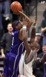 Antonio Burks shoots over Charlotte's Cam Stephens during the first half.