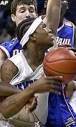 Memphis guard Dajuan Wagner is fouled by DePaul's Rashon Burno on his way to the net during the second half.