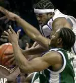 Kelly Wise grabs a rebound from Tulane's Ben Benfield, left, and Waitari Marsh in the closing seconds of the game Monday.