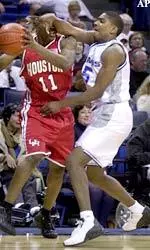 Jeremy Hunt puts the pressure on Houston's Jarrett Sidney during the first half.