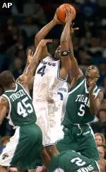 Chris Massie overwhelms Tulane defenders on his way to the basket.