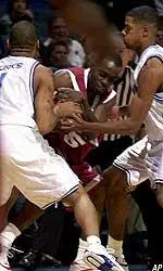 Antonio Burks and Rodney Carney put the pressure on Fordham's Jermaine Anderson during the first half.