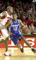 Billy Richmond drives past Louisville's Erik Brown as the Tigers upset the Cardinals 80-73.