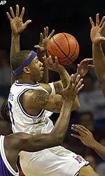 Antonio Burks goes for a shot past several TCU defenders during the first half.