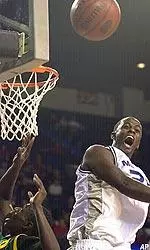 Earl Barron lets out a yell as he rejects a shot attempt by South Florida's Terrence Leather during the first half.