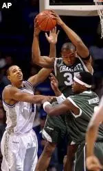 Duane Erwin fights for a rebound with Charlotte's Calvin Clemmons and Curtis Withers, right, during the first half.
