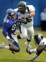 Memphis' Tavarious Davis, left, slips past Tulane defenders Blake Baker, middle, and Brandon Spincer during the first half Saturday, Oct. 16, 2004, in Memphis, Tenn. (AP Photo/The Commercial Appeal, Mark Weber)
