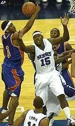 Joey Dorsey and Savannah State's Wesley West fight for a loose ball during the first half.