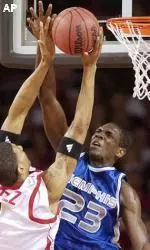 Anthony Rice contests a shot attempt by Louisville's Kendall Dartez during the first half.