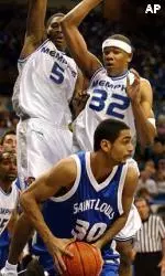Jeremy Hunt (5) and Sean Banks (32) apply defensive pressure on Saint Louis's Izik Ohanan during the first half.