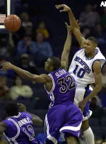 Rodney Carney passes under pressure from TCU's Marcus Sloan.
