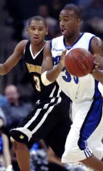 Darius Washington battles for possession with Wisconsin-Milwaukee's Avery Smith. (AP Photo)