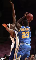 Robert Dozier defends a shot by UCLA's Luc Richard Mbah a Moute during the second half Wednesday at Madison Square Garden in New York.