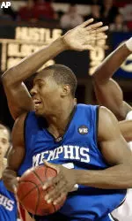 Joey Dorsey encounters the defensive pressure of Louisville players Juan Palacios and Otis George as he goes to the basket during the first half of their game.