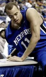 Duane Erwin falls against the courtside tables while chasing a loose basketball during the second half against Saint Louis. (AP Photo/James A. Finley)