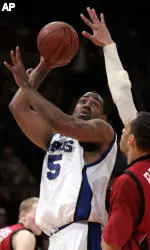 Arthur Barclay shoots over the defense of Saint Joseph's John Bryant in Tuesday's NIT semifinal.